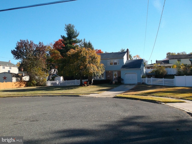 view of front of house with a front yard and a garage