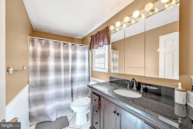 bathroom with toilet, walk in shower, vanity, and tile patterned flooring