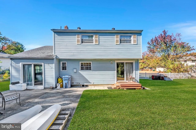 rear view of house featuring a yard and a patio