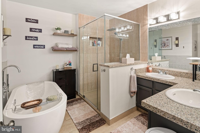 bathroom with tile patterned flooring, shower with separate bathtub, and vanity