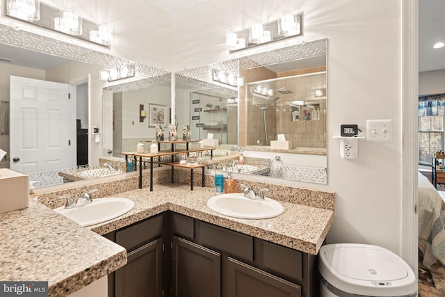 bathroom featuring vanity, toilet, and a shower with door