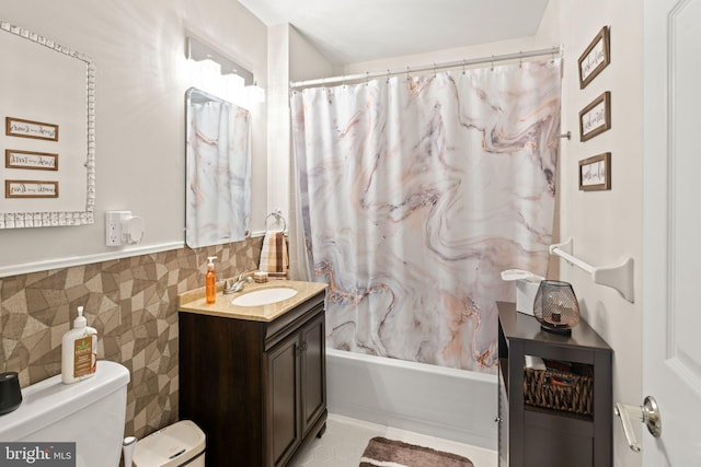 full bathroom with vanity, shower / tub combo with curtain, and toilet