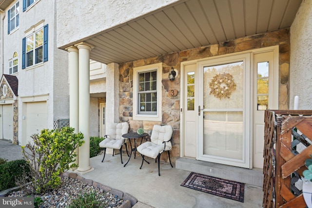 property entrance with a garage and a porch