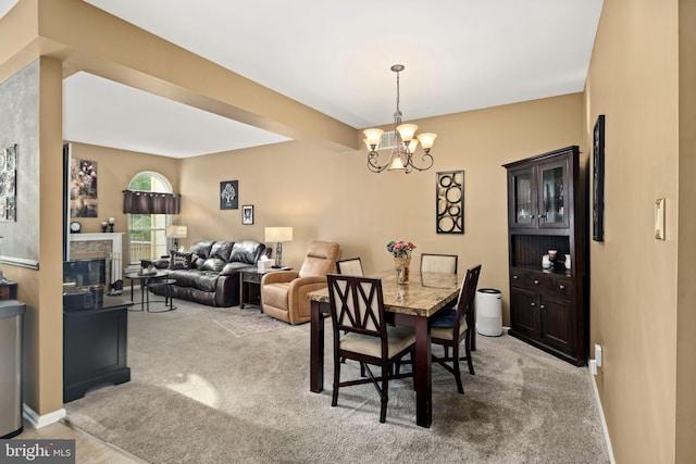 dining area with light colored carpet and an inviting chandelier