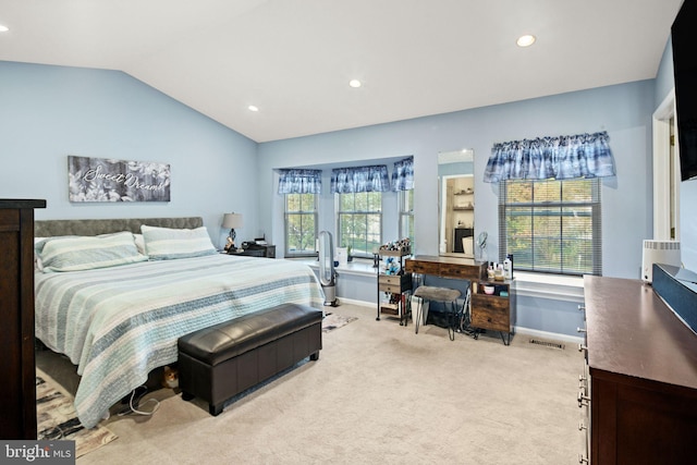 bedroom featuring vaulted ceiling and light colored carpet