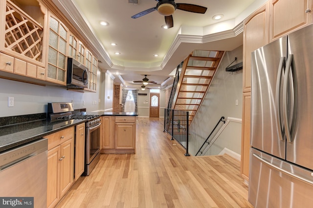 kitchen featuring stainless steel appliances, ornamental molding, light hardwood / wood-style flooring, and light brown cabinets