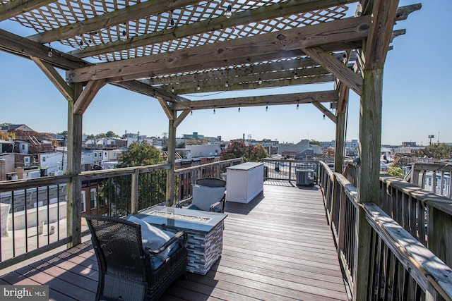 deck featuring a pergola and central AC unit