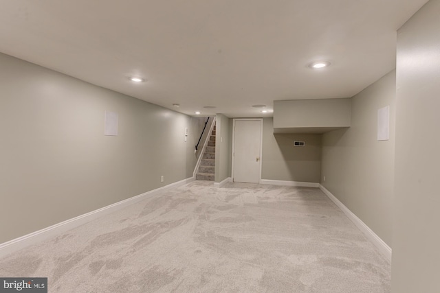 basement featuring light colored carpet