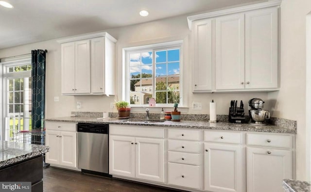 kitchen featuring stainless steel dishwasher, sink, white cabinets, and dark hardwood / wood-style flooring