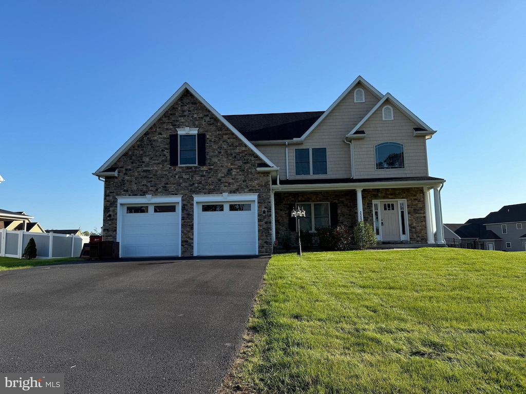 view of front of house with a front lawn and a garage