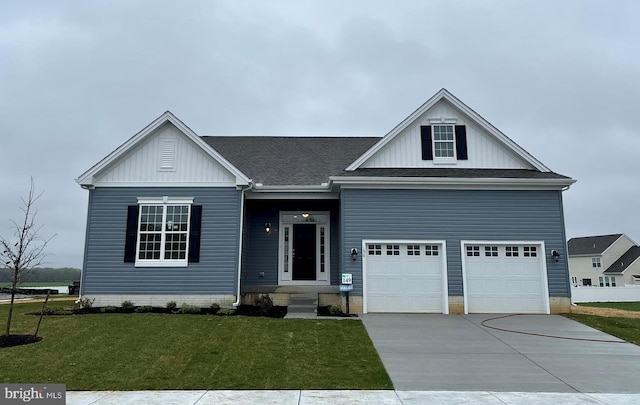 196 Elm Crest Ln, Felton, DE 19943 - view of front of property featuring a garage, concrete driveway, board and batten siding, a shingled roof, and a front yard