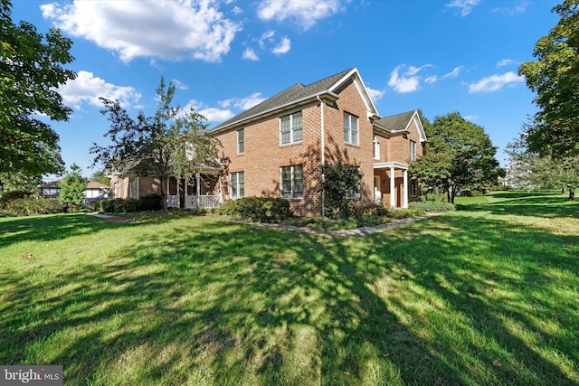 back of house with a lawn