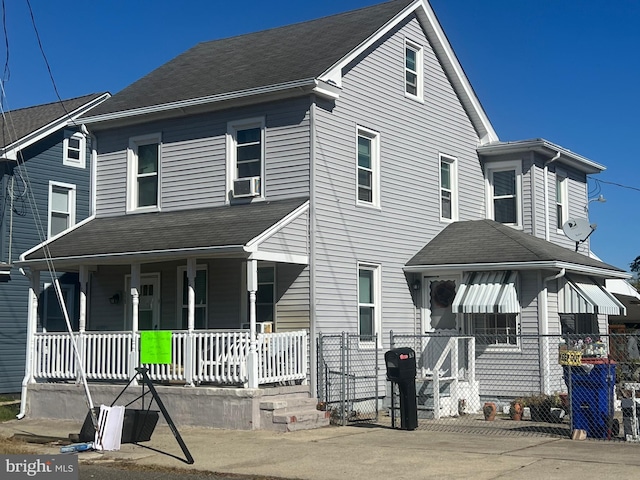 view of front of property featuring a porch and cooling unit