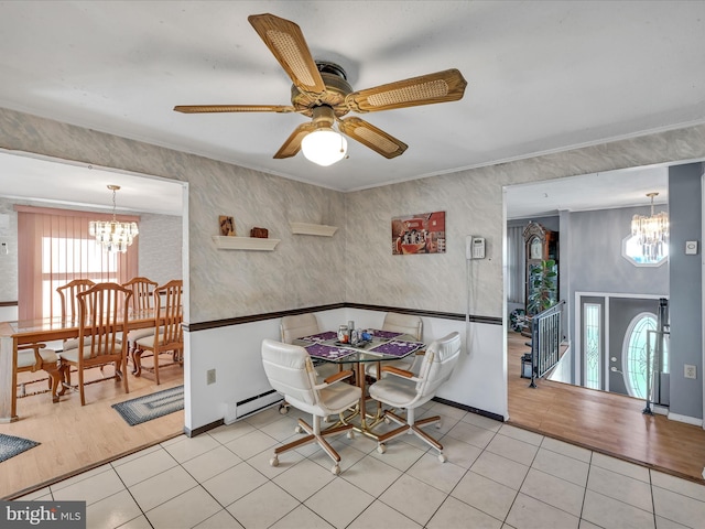 dining area featuring light hardwood / wood-style floors, baseboard heating, and ceiling fan with notable chandelier