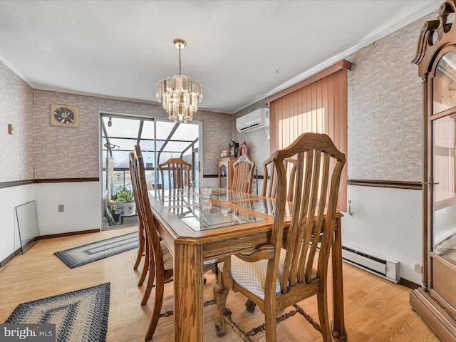 dining room featuring light hardwood / wood-style flooring, a healthy amount of sunlight, and a baseboard radiator