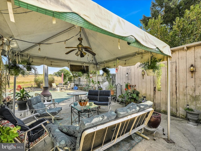 view of patio / terrace featuring ceiling fan, a gazebo, and outdoor lounge area