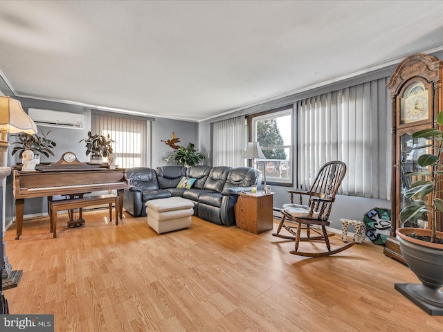 living room with an AC wall unit, crown molding, and light hardwood / wood-style floors