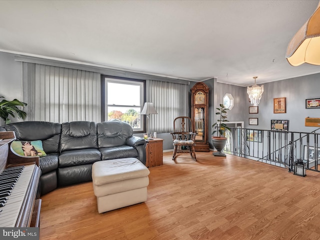 living room with light hardwood / wood-style floors and a chandelier