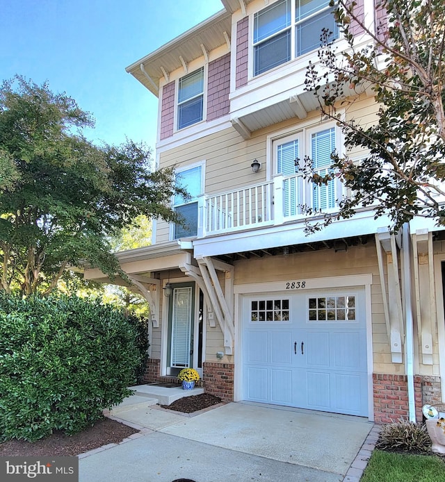 view of front facade featuring a balcony and a garage