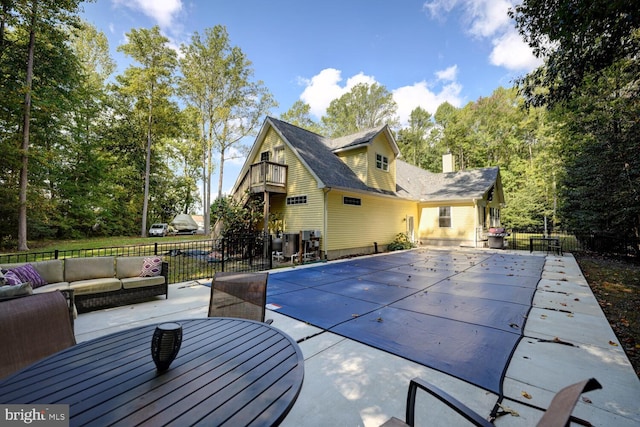 view of swimming pool featuring a patio and an outdoor living space