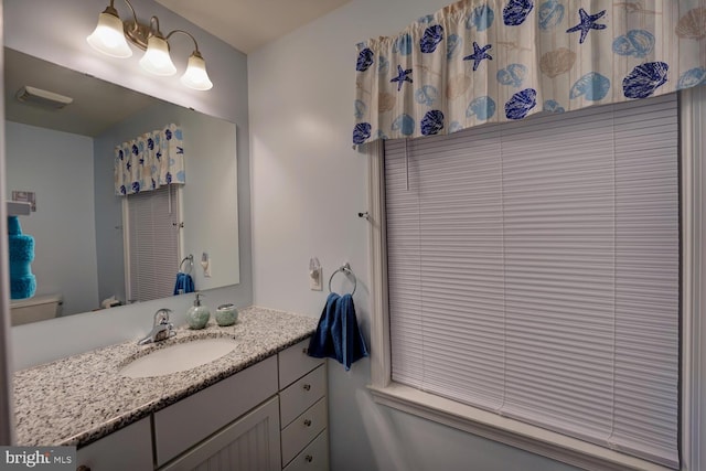 bathroom with vanity and toilet