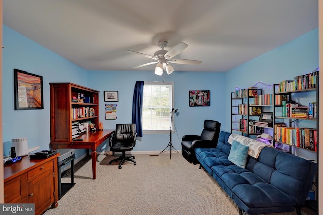 carpeted office space featuring ceiling fan