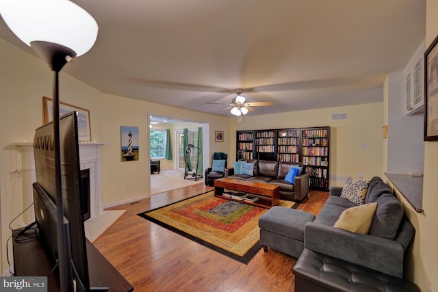 living room featuring light hardwood / wood-style floors and ceiling fan