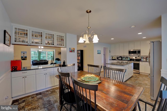 dining space with a chandelier