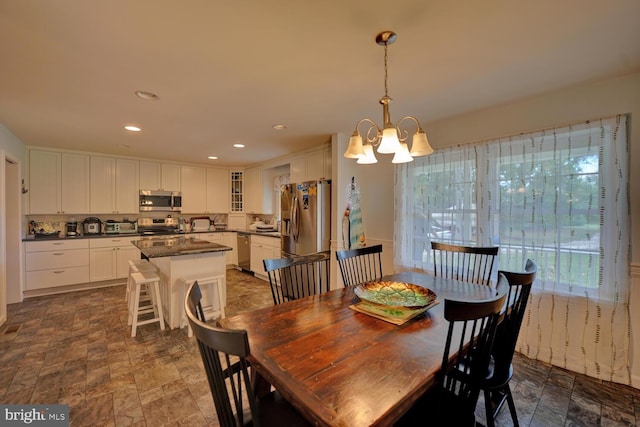 dining space featuring a notable chandelier