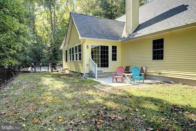 back of house with a yard and a patio area