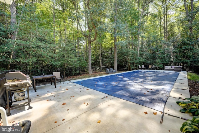 view of pool featuring grilling area and a patio