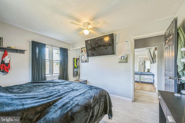 bedroom with ceiling fan and light hardwood / wood-style floors