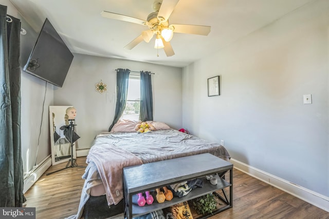 bedroom with dark wood-type flooring, ceiling fan, and a baseboard radiator