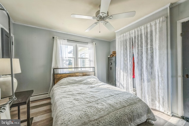 bedroom featuring a baseboard radiator, ceiling fan, crown molding, and light hardwood / wood-style flooring