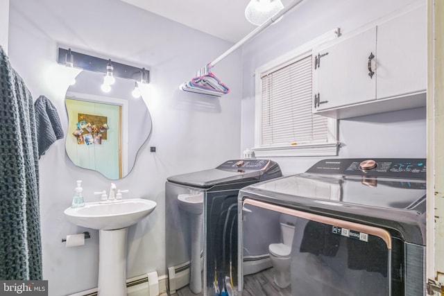 laundry room featuring hardwood / wood-style flooring, sink, and separate washer and dryer