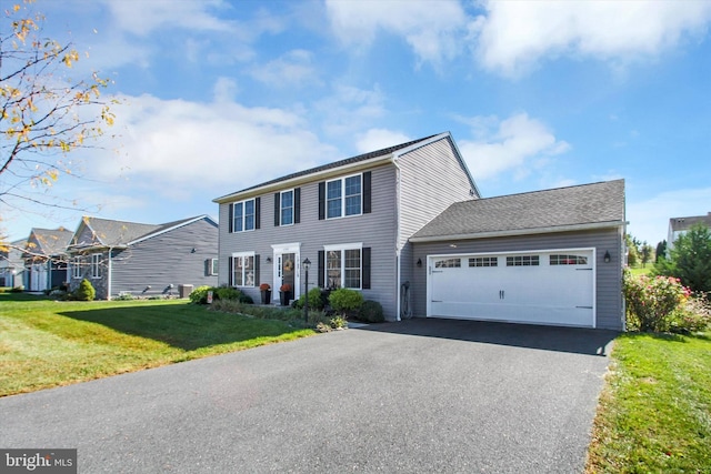 view of front of house featuring a front yard and a garage