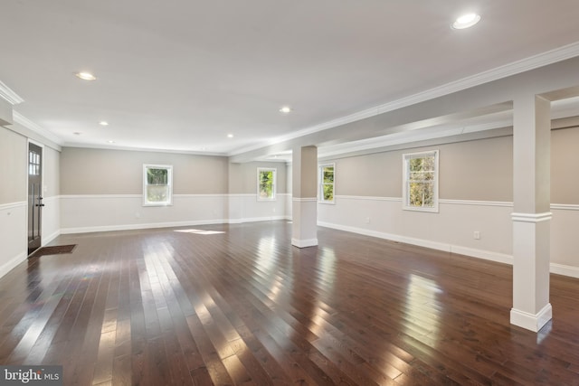 interior space with ornamental molding, dark wood-type flooring, and decorative columns