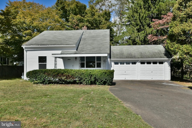 view of front of home with a garage and a front lawn