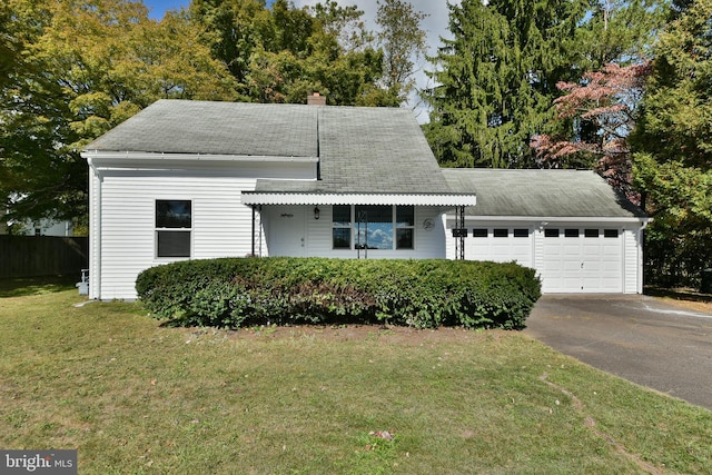 view of front of property featuring a garage and a front lawn