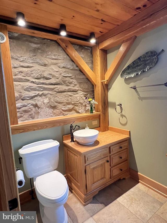 bathroom featuring toilet, vanity, tile patterned floors, and wood ceiling