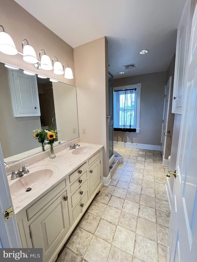 bathroom featuring vanity and a shower with shower door