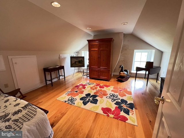 bedroom with hardwood / wood-style flooring and vaulted ceiling