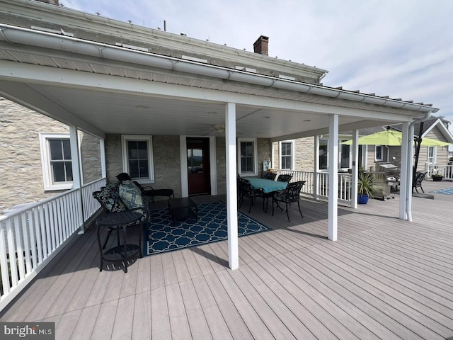 wooden terrace featuring ceiling fan