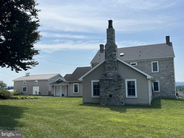 rear view of house with a yard