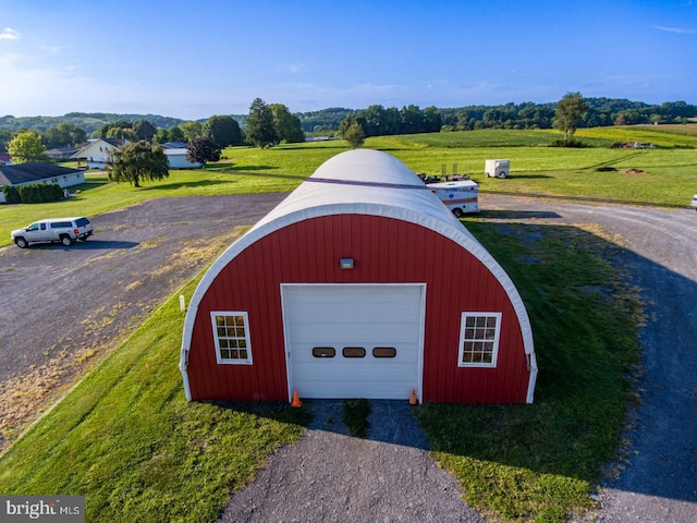 view of outdoor structure with a rural view and a garage