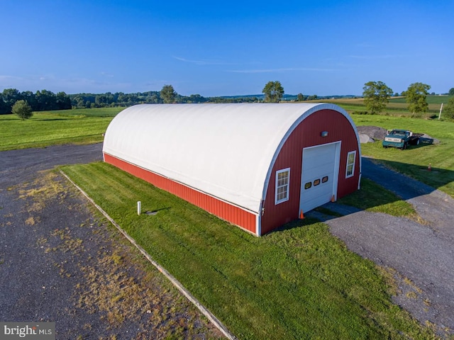 view of outdoor structure with a rural view and a garage