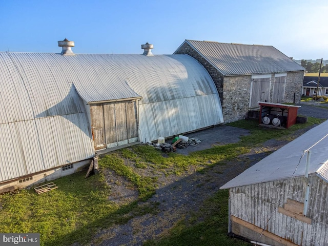 view of property exterior with an outbuilding