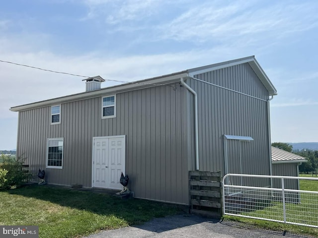 view of outdoor structure with a lawn