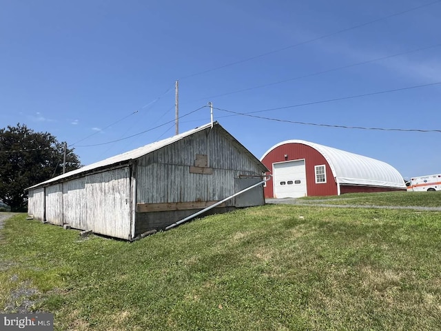 view of outdoor structure featuring a lawn