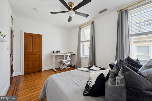 bedroom with hardwood / wood-style flooring and ceiling fan